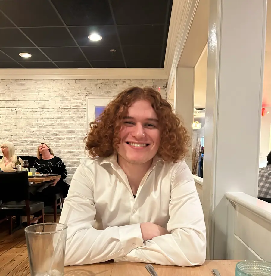 Isaiah smiling at a restaurant table